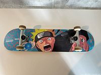 Underside full view showing deck graphics, trucks and wheels