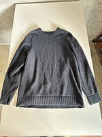 Full view of Lululemon long-sleeve top laid flat