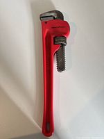 Full view of red Benchmark 14" pipe wrench