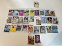 Overview of entire collection laid out, showing graded card and 35 sleeved cards