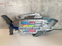 Full view grey plastic shark storage case on tabletop