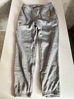Full view of grey sweatpants laid flat
