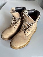 Pair of tan Timberland boots front view showing laces and toes