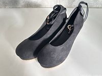 Pair of black platform wedge shoes, top and side view