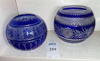 Two cobalt blue cut-to-clear crystal rose bowls side by side