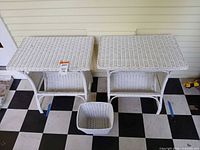 Front view of both white wicker side tables and waste basket on floor