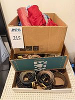 Stacked boxes showing umbrellas, scarves and belts