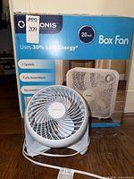 Box showing Pelonis 20-inch box fan features with Honeywell HT-904 fan in front