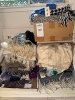 Boxes and shelves with blankets, scarves, socks