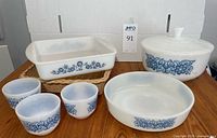 Group shot showing all milk glass pieces and wicker holder