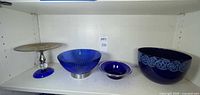 Shelf view showing all four cobalt blue items side by side