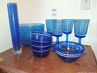 Group shot of entire cobalt blue ribbed glass collection showing vase, bowls and goblets