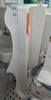 Full side view of white curved freestanding shelf beside sink