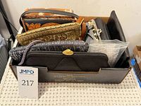 Box containing assorted purses viewed from top
