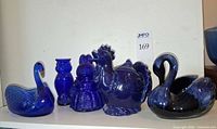 Front view showing all five cobalt blue glass and ceramic animal pieces