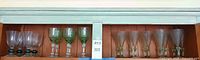 Shelf view showing all three patterns of green accent stemware