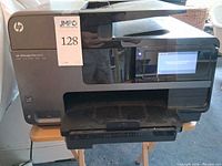 Front view showing HP OfficeJet Pro 8620 printer, touchscreen and output tray