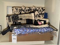 Box of assorted handbags and totes on shelf