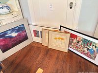 Group shot showing five framed artworks: landscape, geometric triptych, two floral prints, Japanese print