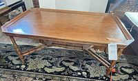 Top and legs of faux-bamboo coffee table full view