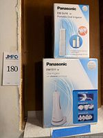 Retail boxes of Panasonic EW-DJ10-W and EW1511-W oral irrigators