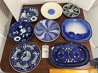 All eight blue and white ceramic pieces laid out for overview