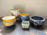 Front view of five ceramic planters and bowls