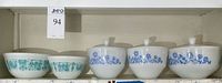 Shelf view of two Pyrex bowls and three Federal Glass casseroles with lids