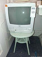 RCA CRT TV/VCR combo on round wicker table