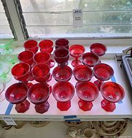 Group view of all ruby red stemware pieces on shelf