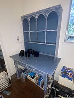 Full view of blue distressed wood hutch buffet with removable top shelving