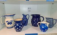 Front view of all six ceramic pitchers