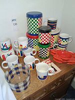 Full lot showing canisters, mugs, crab ashtrays, glass bowl, keychain packaging