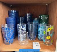 Shelf view of assorted plastic tumblers and cups
