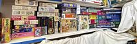 Shelves filled with varied puzzle boxes showing quantity and range