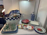 Group view of plates, bucket, glasses, trays and thermos