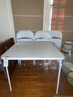 Table and three chairs front view