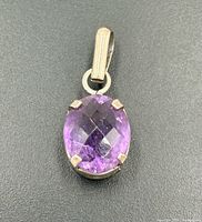 Front view of amethyst pendant showing faceted stone and prong setting