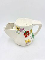 Front view showing floral design and soap compartment