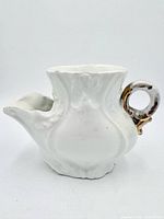 Left side view showing relief body, spout and handle
