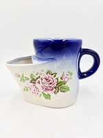Front view showing floral motif and blue gradient glaze