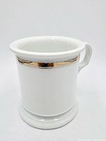 Frontal view of porcelain scuttle shaving mug