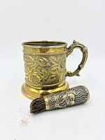 Mug and brush front view showing ornate designs