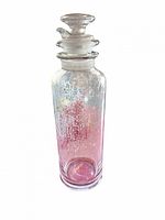 Full view of bottle with stopper showing iridescent pink tint