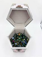Open hexagonal case filled with marbles