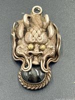 Front view of dragon head pendant showing design details