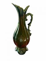 Full side view of glazed ceramic pitcher showing color gradient, handle, and pedestal base