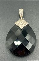 Front view showing faceted onyx surface and silver cap