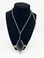 Necklace displayed on bust showing full chain and pendant