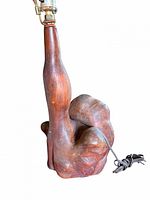 Side view of sculpted burl wood lamp base, socket mount and cord visible